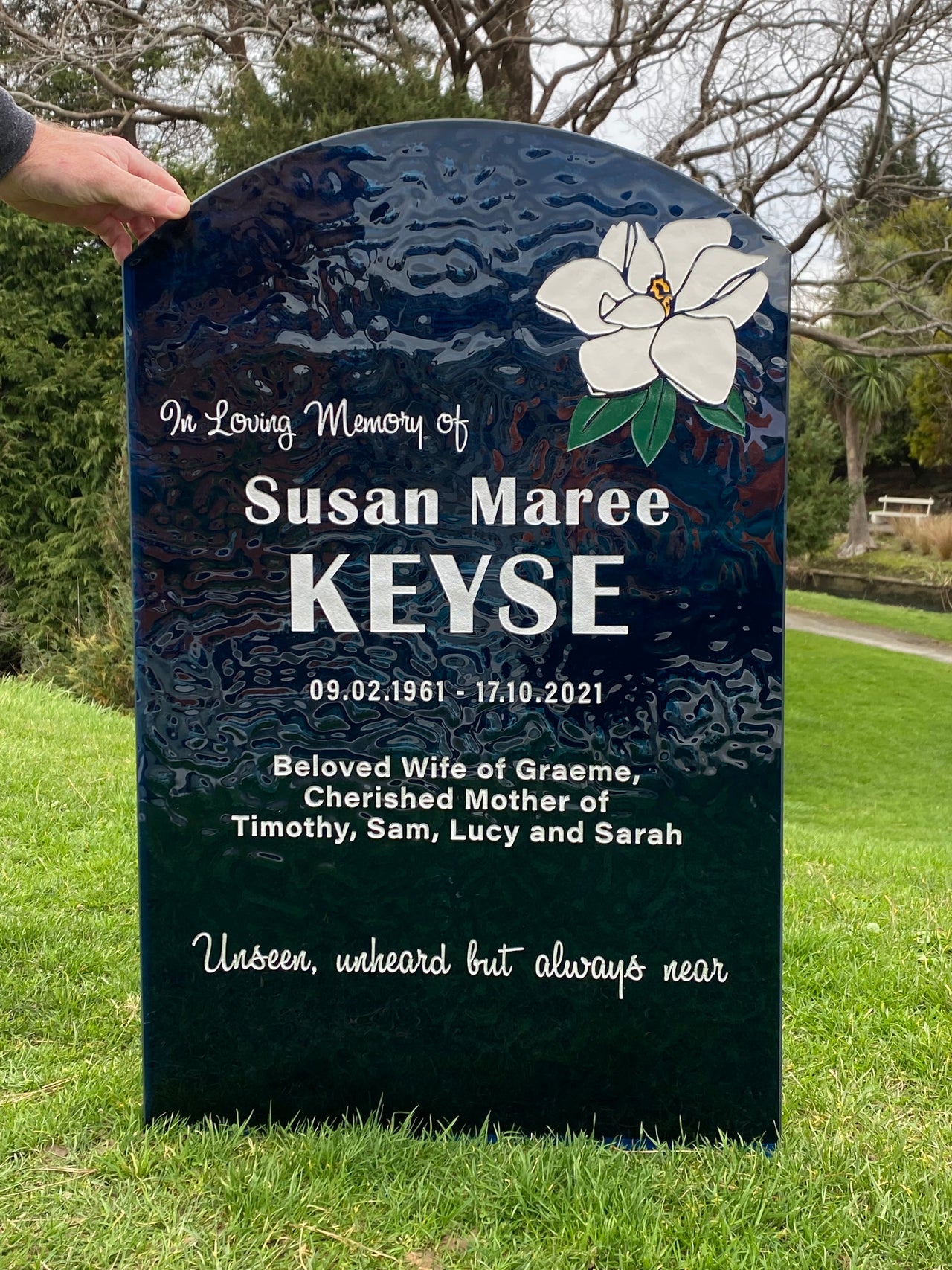 Blue Glass headstone with white flower