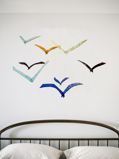 Glass Sea Birds on wall behind a bed