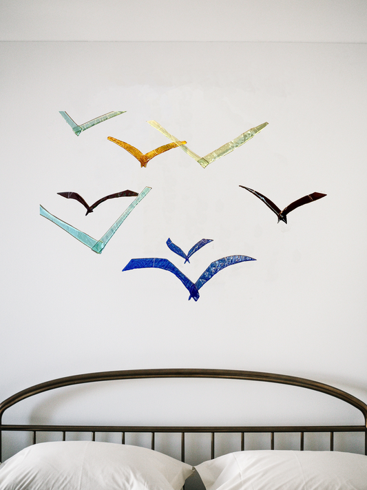 Glass Sea Birds on wall behind a bed