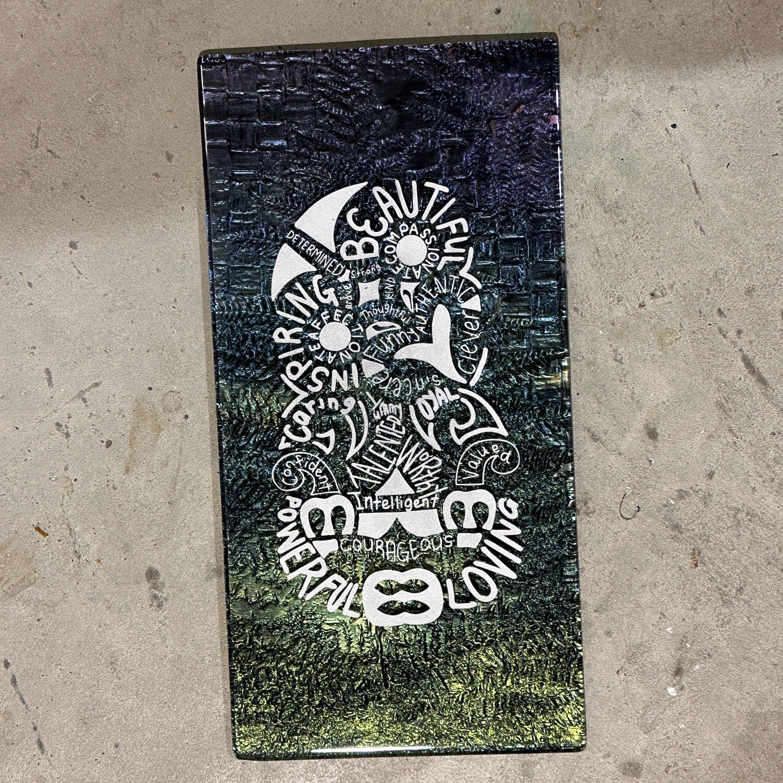 glass art affirmations in the shape of an NZ tiki