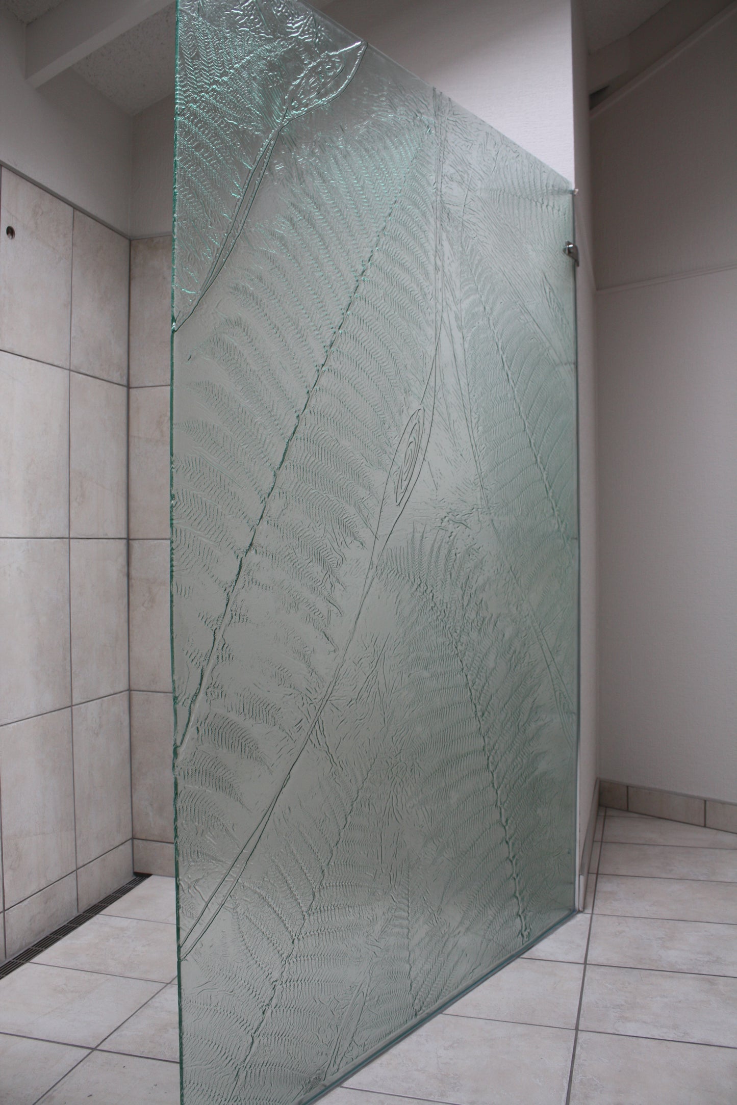 Large privacy panel with ferns slumped in bathroom shower