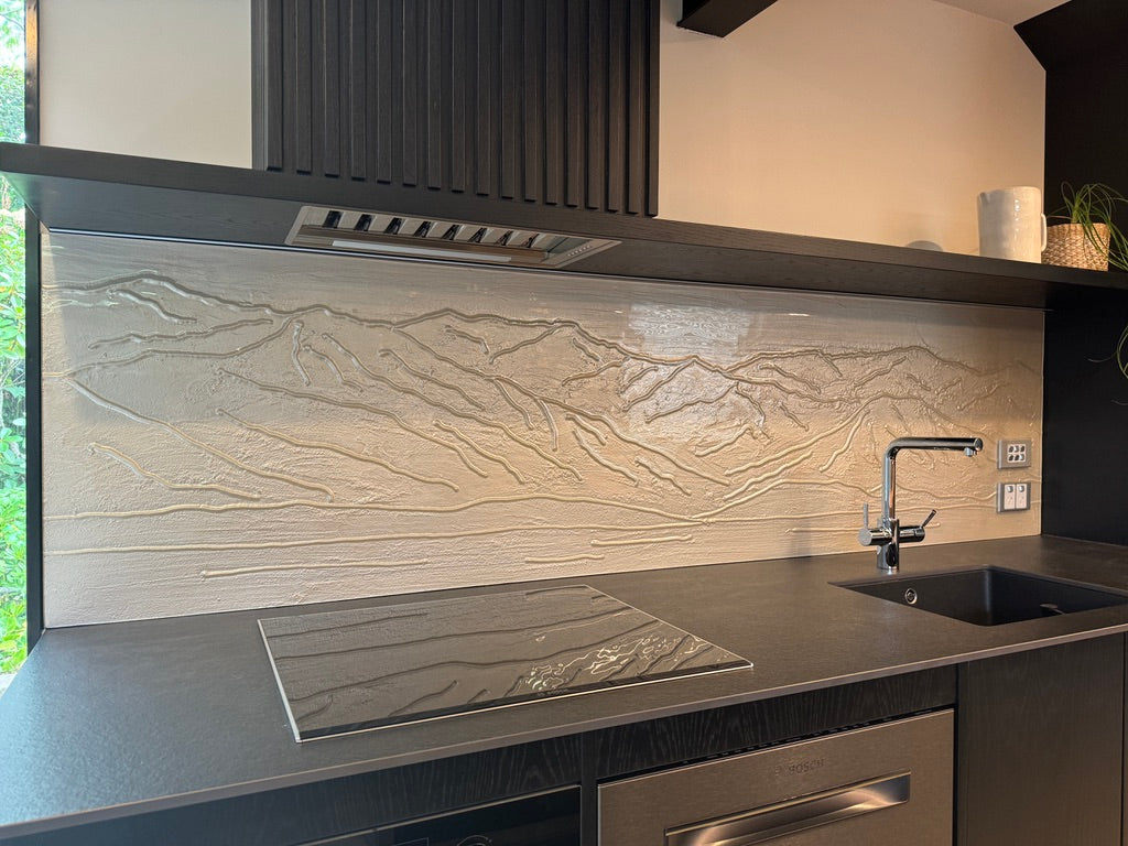 Mountain splashback in white handrawn slumped glass for a kitchen