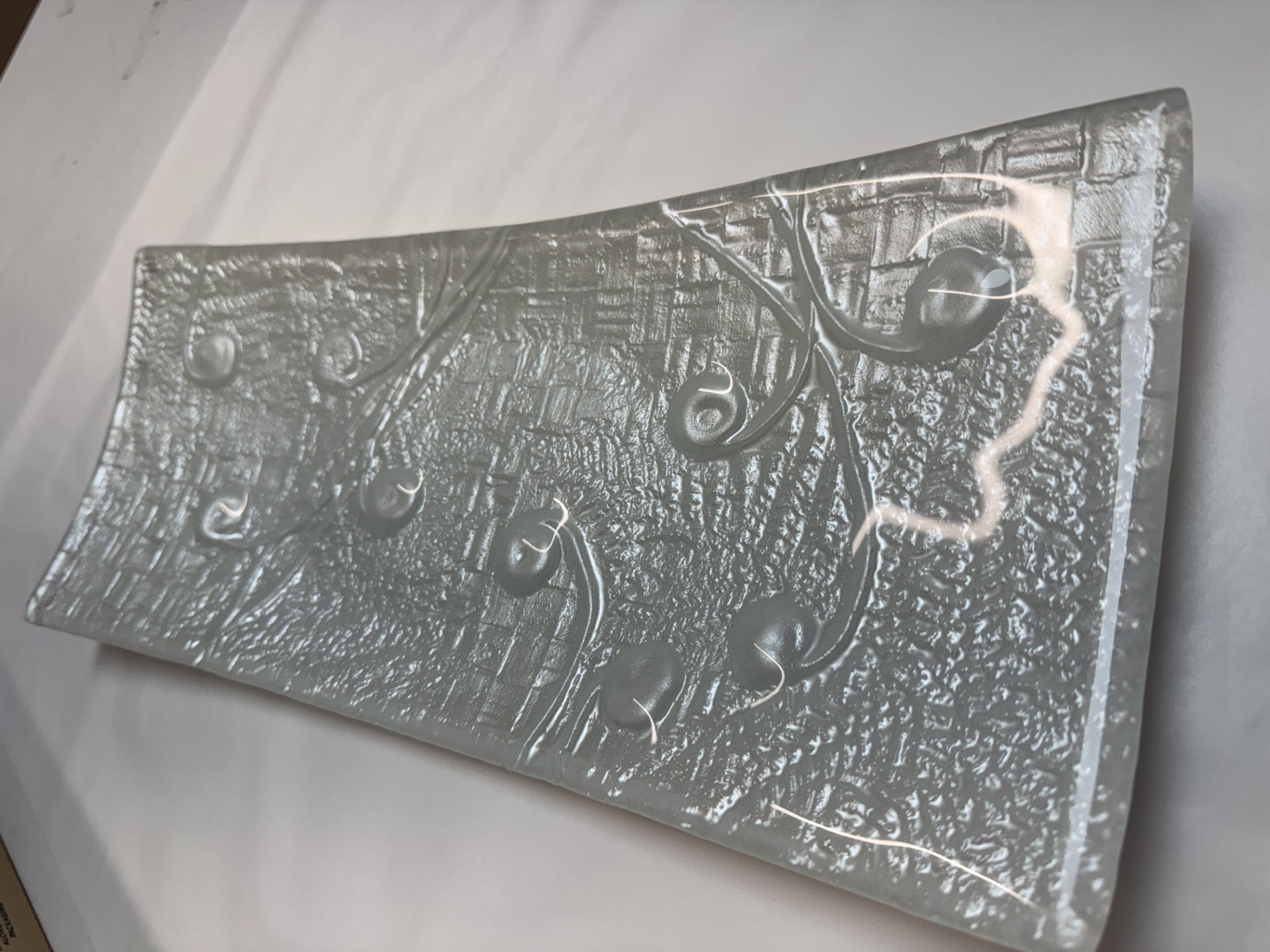 Metallic textured object on a white background